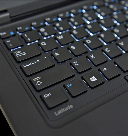 Dell 14-inch Latitude 5590 keyboard close-up on a light gaming laptop.
